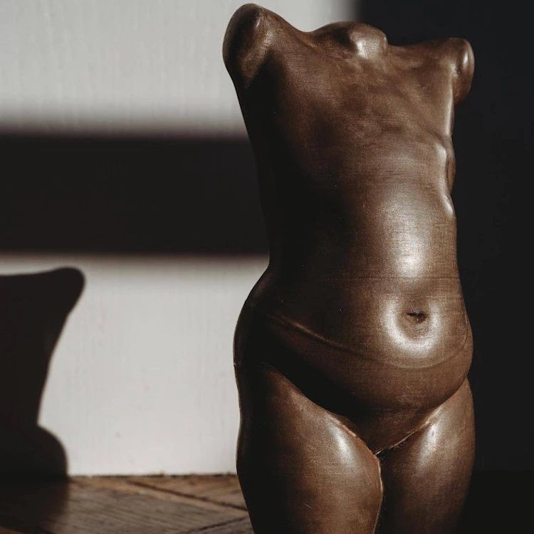 Wood-effect sculpture of a woman's torso after mastectomy